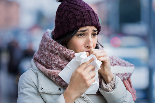 Woman coughing in winter