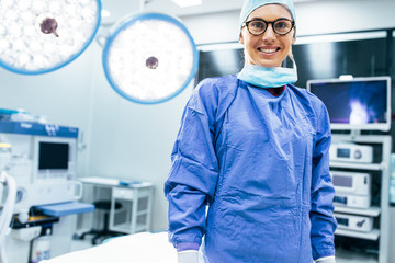 Smiling female surgeon in surgical uniform at operating room