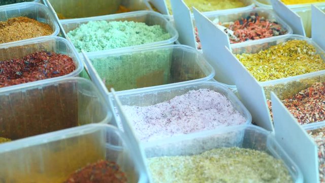 Spices, nuts, dried fruits on display at market on the counter, 4k, slow-motion