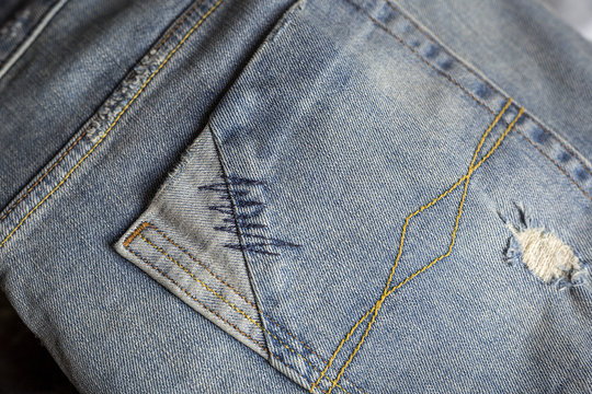 Details of blue jeans in zipper, pockets