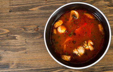 soup with chicken and mushrooms on a wooden background. with copy space. top view