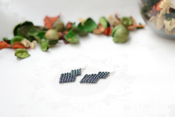 Black beaded earrings hematite color close up