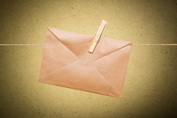 Blank envelope hanging on rope on wooden clothespin