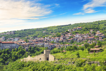 Fototapeta na wymiar A beautiful view of the Tsarevets fortress among the green hills in Veliko Tarnovo, Bulgaria