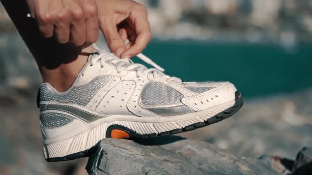 Woman Tying Sports Shoe