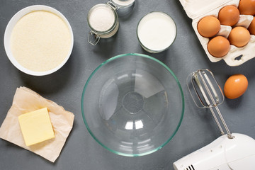 The process of preparation of the manna in the kitchen. Ingredients: semolina, sugar, yogurt, oil, eggs. The view from the top.
