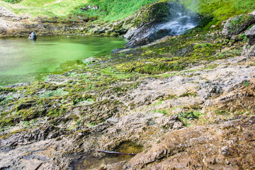 Dreamy waterfall and small emerald pond. Karst water. Fontanon of Goriuda. Friuli