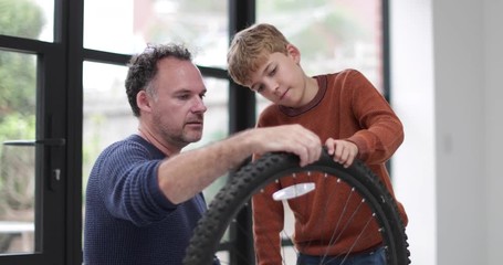 Father teaching Son how to care for his bicycle
