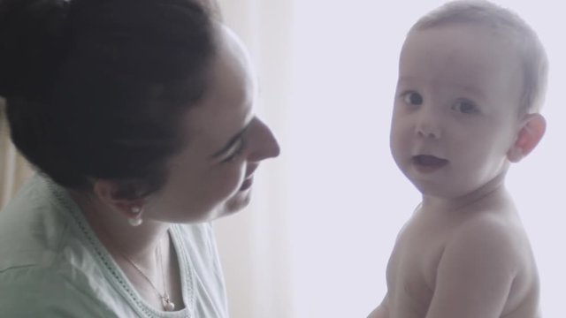 Mother kissing her child slow motion