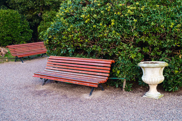 Red painted bench in Royal Gardens or Giardinetti Reali on Riva degli Schiavoni adjacent to St Marks Square Venice.