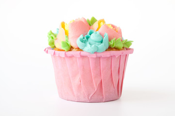 Pink cupcake with white whipped cream in form of flower on white background. Picture for a menu or a confectionery catalog. Cutout.