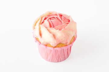 Pink cupcake with white whipped cream in form of flower on white background. Picture for a menu or a confectionery catalog. Cutout.