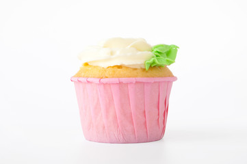 Pink cupcake with white whipped cream in form of flower on white background. Picture for a menu or a confectionery catalog. Cutout.