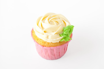 Pink cupcake with white whipped cream in form of flower on white background. Picture for a menu or a confectionery catalog. Cutout.