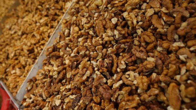 Spices, nuts, dried fruits on display at market on the counter, 4k, slow-motion