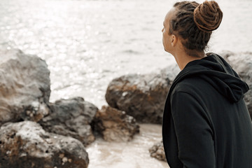 close up of handsome hippie styled man outdoors at sunset