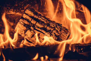 Wood in the flames of cozy fireplace