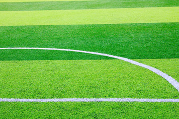 Obraz premium Photo of a green synthetic grass sports field with white line shot from above