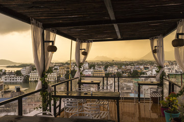 Roof top restaurant with beautiful view to Lake Pichola in the morning in Udaipur, Rajasthan, India