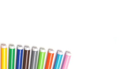 Fototapeta premium Varicoloured markers on the white isolated background.