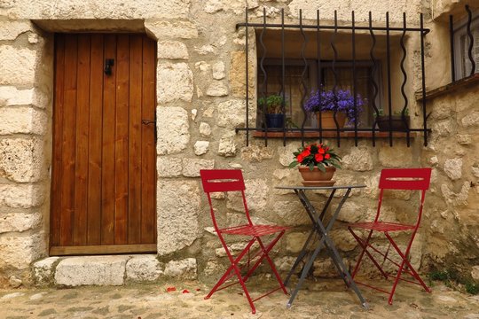 café table and chairs in medieval street in village of Gourdon, Provence, France