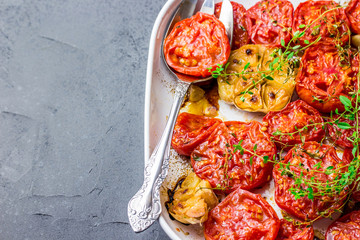 Roasted tomatoes with garlic and herbs. Top view, space for text. 