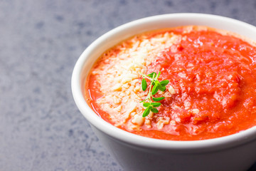 Roasted tomato and basil soup.  Selective focus, close up, space for text.