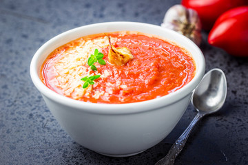 Crock pot tomato and basil soup. Selective focus, space for text.