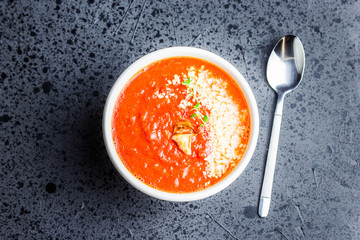 Slow cooker roasted tomato, parmesan and basil soup. Top view, copy space. 