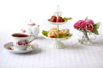 Cream puffs with berries on a stand