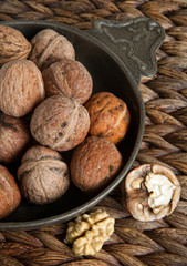 Vintage pewter bowl filled with rustic autumn walnuts