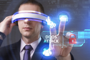 Business, Technology, Internet and network concept. Young businessman working in virtual reality glasses sees the inscription: Ddos attack