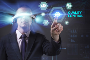 Business, Technology, Internet and network concept. Young businessman working in virtual reality glasses sees the inscription: Quality control