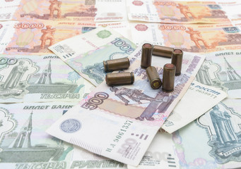Bullets lie on Russian money in a chaotic manner