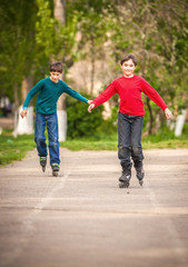 Three children on inline skates in park