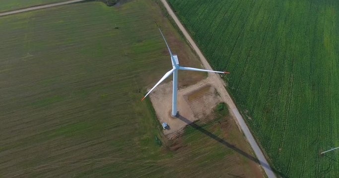 Wind farms in the field, rotating blades, aerial view, alternative renewable energy sources. Wind  turbine, view from a height.