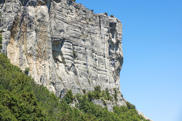 vertical mountain . Rock climbing the steep cliffs of the mountains .