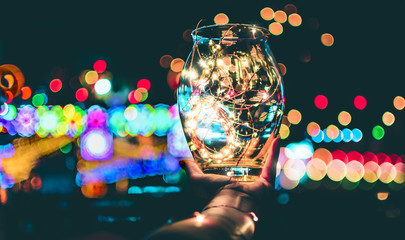 Abstract bokeh of festive lights through a glass jar at twilight