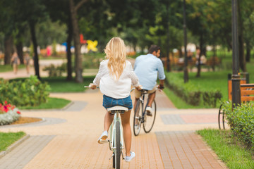 couple riding bicycles in park