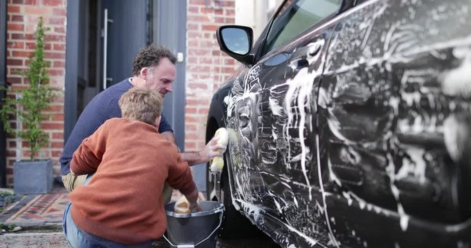 Father and Son washing a car together