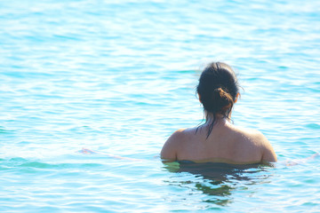 Natural woman taking a bath in the sea. Empty copy space for Editor's text.