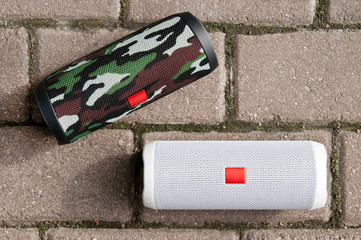 Two speakers on the granite background. The view from the top. Outdoors in Sunny weather.