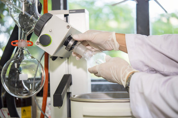 Scientists are installing machines. A rotary evaporator  is a device used in chemical laboratory for the efficient and gentle removal of solvents from samples by evaporation. 
