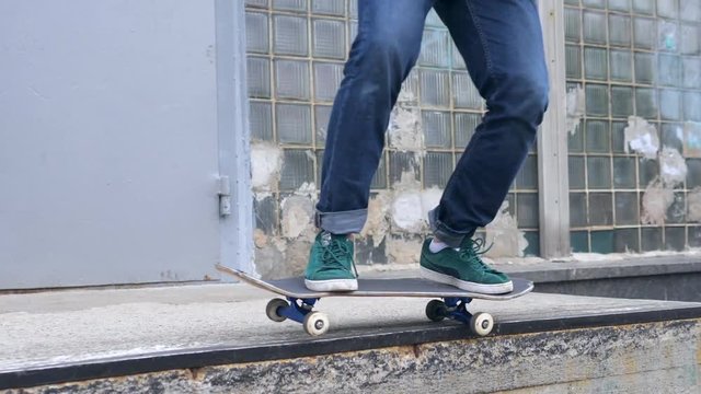 Skater Doing Kickfip to 50-50 Grinding Trick in Skatepark. Close up Slow Motion in 180fps, HD.