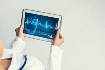 Close of female doctor hands working with tablet pc computer