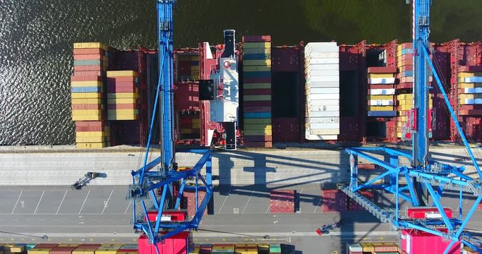 Aerial view of container ship anchored in the port and loaded with containers