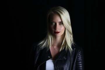 Beautiful vampire girl posing on a black background 