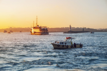 Fototapeta premium Evening Bosphorus sunset with boat ferry lighthouse Istanbul October
