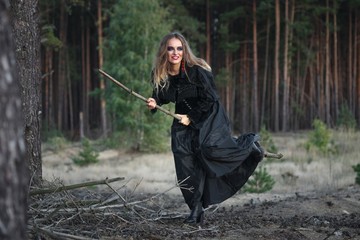 beautiful girl in a black dress in the forest.