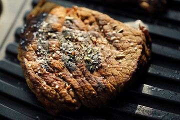 Tasty fresh grilled meats with spices and salt